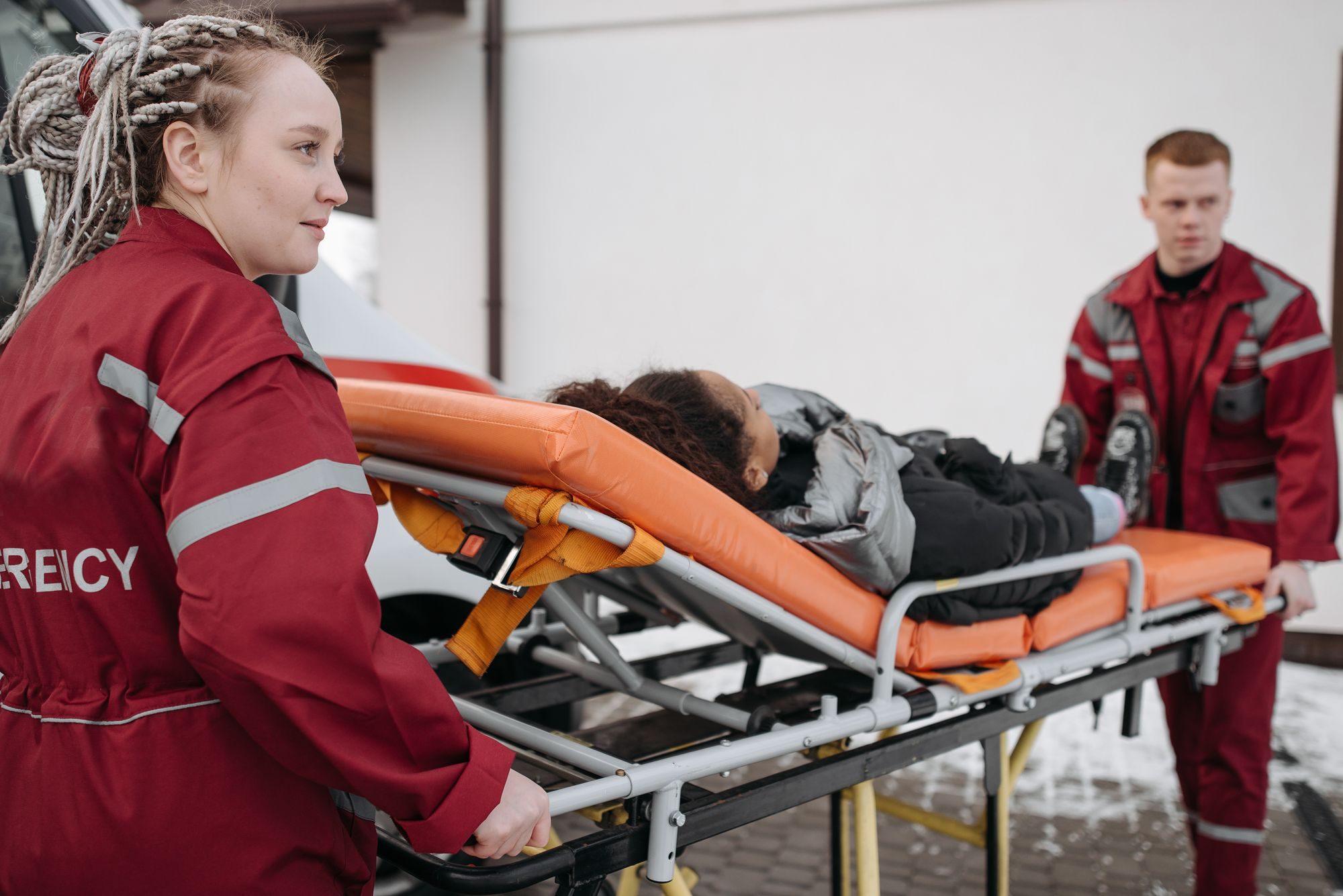 Ambulance crew moving a patient on a stretcher
