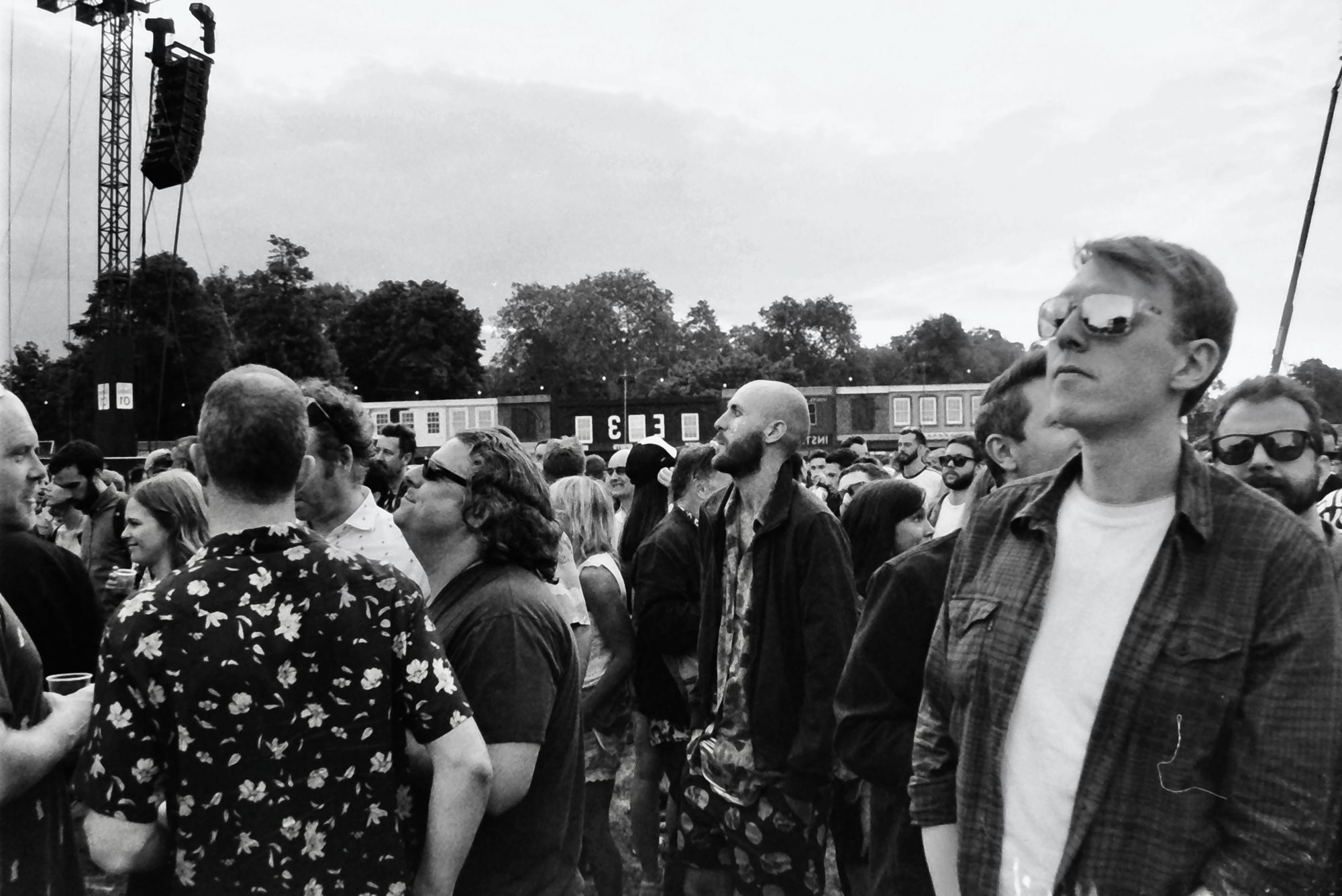 Black and white photo of a crowd at an outdoor music festival in England