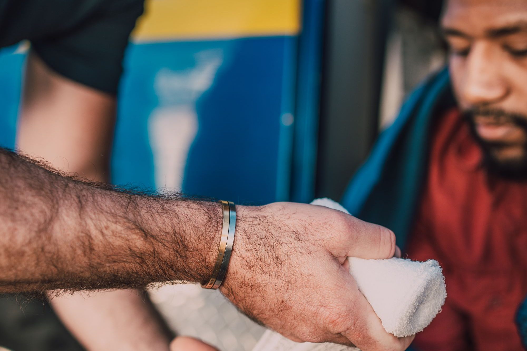 A clinician bandaging a patient’s injured hand
