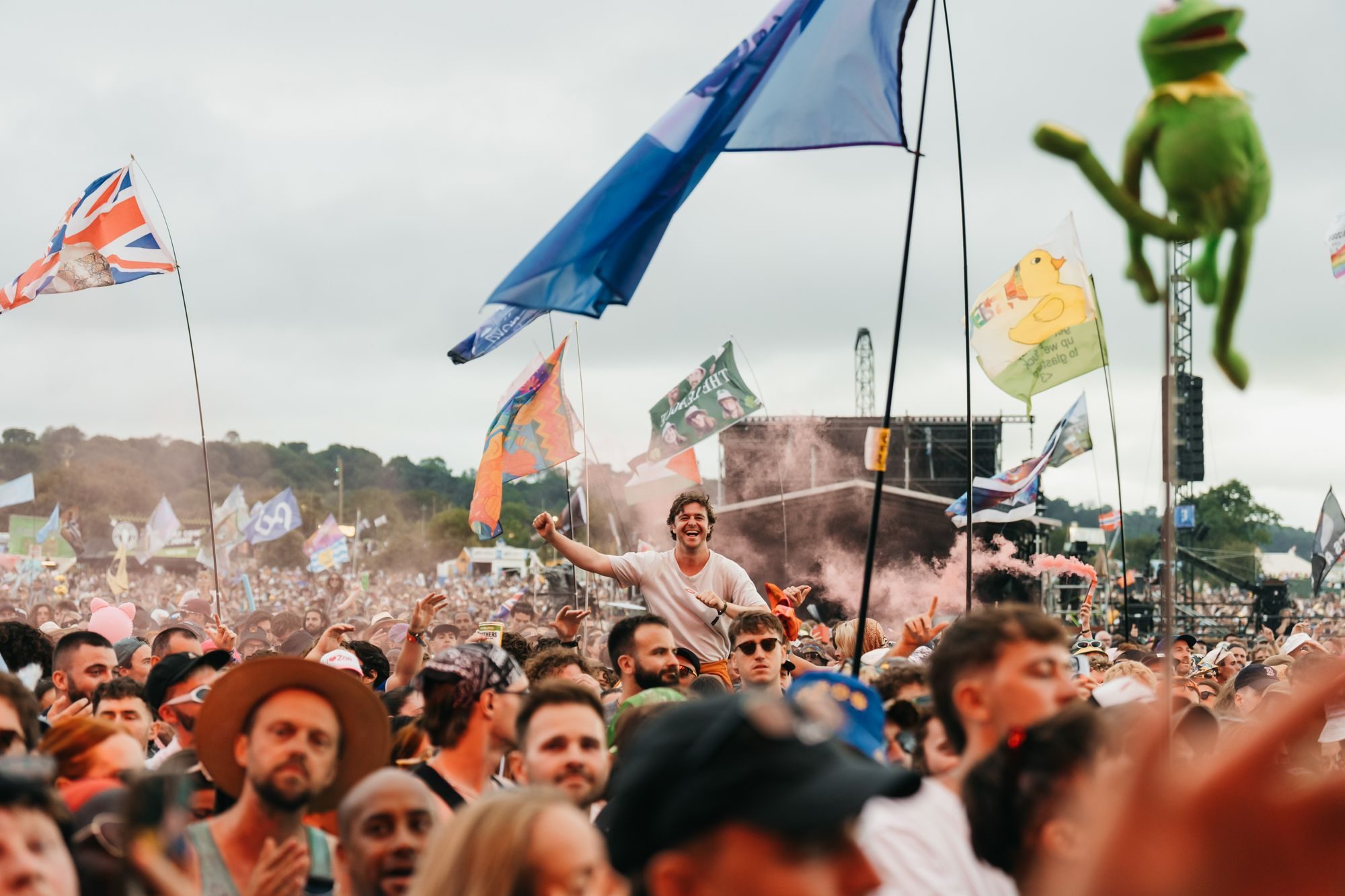 Festival crowd with flags at an outdoor music event in England