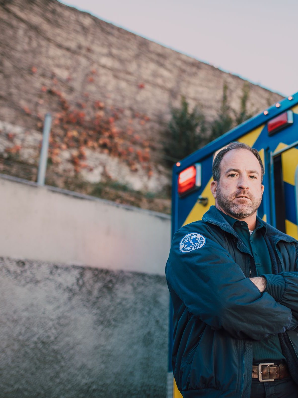 An ambulance crew member standing beside an ambulance