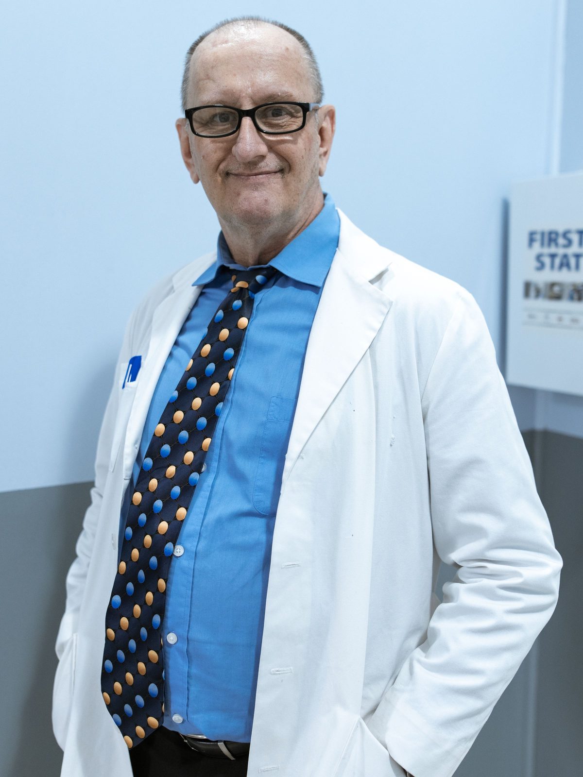 A senior doctor in a white coat